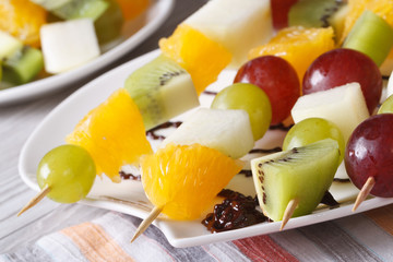 Fresh fruit oranges, kiwi, grapes and pears macro