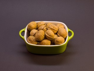 Small bowl full of walnuts isolated