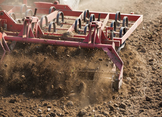 Close up shot of seedbed cultivator machine at work