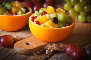 Oranges stuffed with fresh fruit salad close-up horizontal