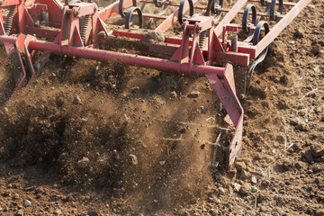 Close up shot of seedbed cultivator machine at work