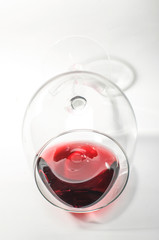 Red wine in the glass on the bright background