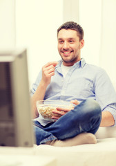 smiling man watching sports at home