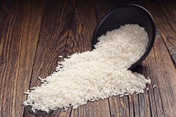White rice in bowl and scattered near