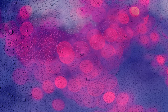 defocused bokeh lights past glass and drop