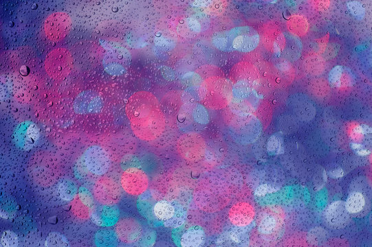 defocused bokeh lights past glass and drop