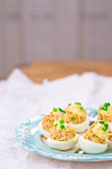 delicious stuffed eggs on blue plate.