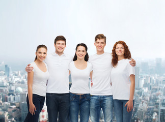 group of smiling teenagers in white blank t-shirts