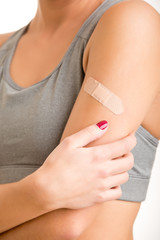 Woman With Adhesive Bandage on Her Arm