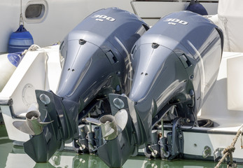 Pair of  blue chromed outboard engines installed on a white pleasure boat - find more in my portfolio 