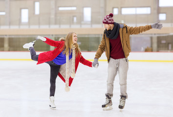 happy couple holding hands on skating rink
