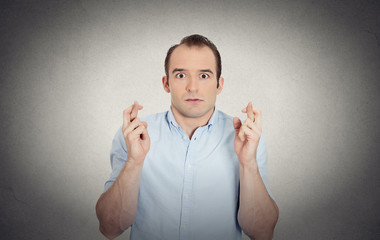 funny guy, anxious business man crossing fingers hoping  