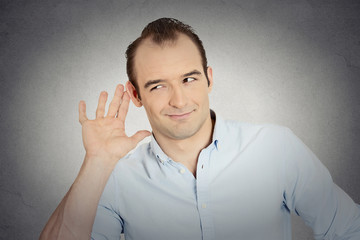 young nosy man secretly listening conversation eavesdropping