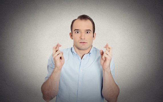 funny guy, anxious business man crossing fingers hoping  