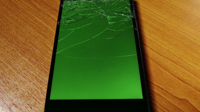 Broken Screen High-End Oppo Smartphone with Green Background