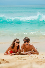 happy couple in sunglasses on the beach