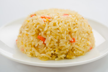 Rice and vegetables on a plate with a white background.