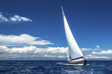 Ship yachts with white sails in the open Sea. Luxury boats. - obrazy, fototapety, plakaty