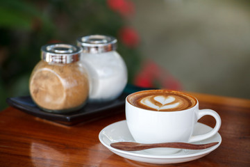 Cup of latte coffee on blue wooden table
