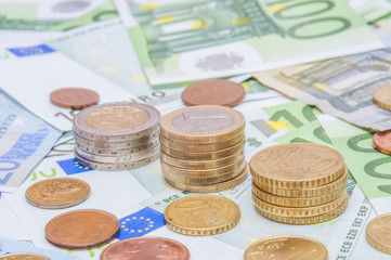 Euro banknotes and euro coins in simple example