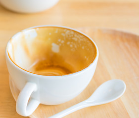 Empty white cup of hot coffee latte on wooden table