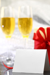 Card with two glasses of champagne and gift box