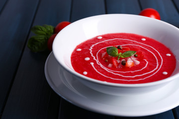 Gazpacho soup on color wooden background
