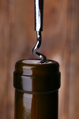 Bottle opener close-up, on wooden background