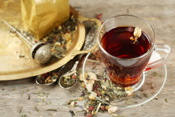 Beautiful vintage composition with herbal tea, on wooden table