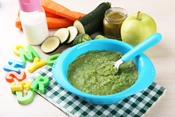 Fresh baby food in bowl with spoon