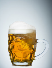 Mug full of fresh beer isolated on white background