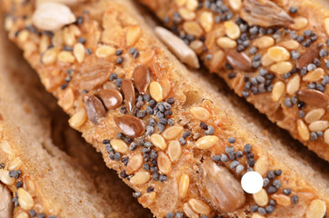 Slices whole grain bread decorated with natural cereals.
