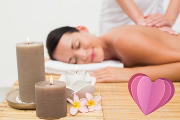 Obraz na płótnie Canvas Composite image of beautiful brunette enjoying a back massage