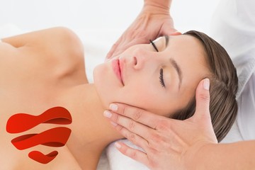 Attractive young woman receiving facial massage