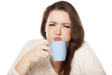 young woman is squeamish from the tea