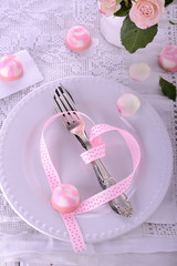 Romantic holiday table setting, on wooden background