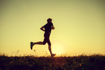 Running man silhouette in sunset time