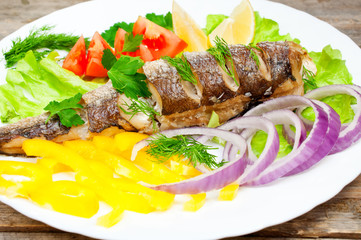 fish hake baked with vegetables on a plate