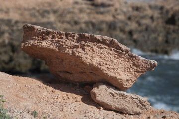 Coastal erosion - fallen chunk of red rock
