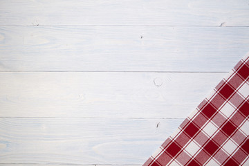 red folded tablecloth over old wooden table