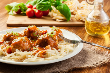 Pasta fettuccine and meatballs with tomato sauce