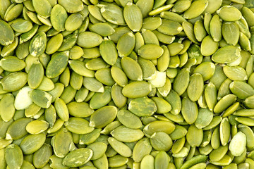Macro background texture of green pumpkin seeds