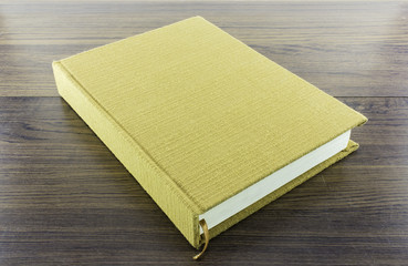 brown notebook on wood