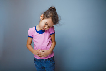 girl winced in pain holding his hands over stomach