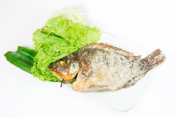 salted grill snakehead fish with herbs on white background