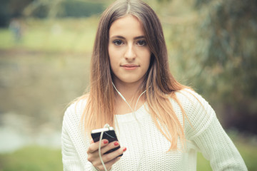 young beautiful woman girl autumn listening music