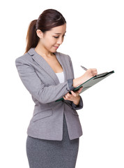 Businesswoman write on clipboard