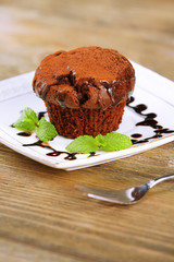 Yummy chocolate cupcake on table