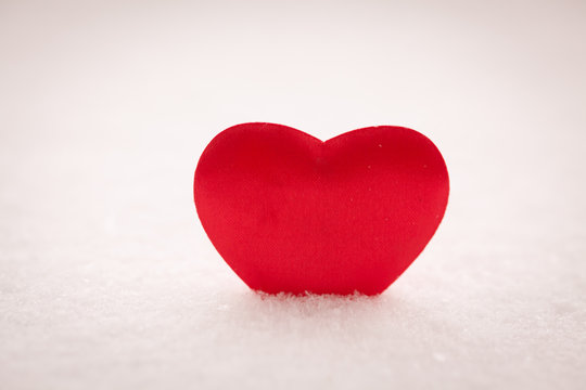 Red heart on snow