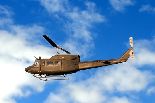 Military helicopter Augusta Bell AB-212, flying low